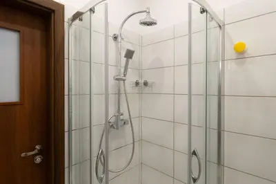 a bathroom with a shower with a glass door at May A studio in Kraków