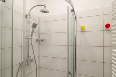 a shower with a glass door in a bathroom at May A studio in Kraków