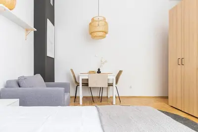 a living room with a table and a couch at May B studio in Kraków
