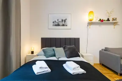a bedroom with a bed with towels on it at May B studio in Kraków