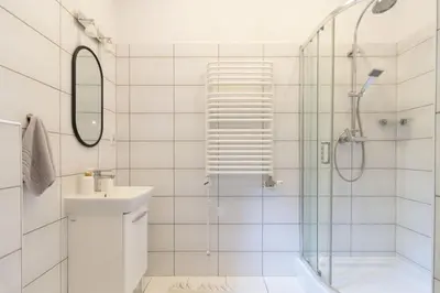 a bathroom with a shower and a toilet and a sink at May C studio w/balcony in Kraków