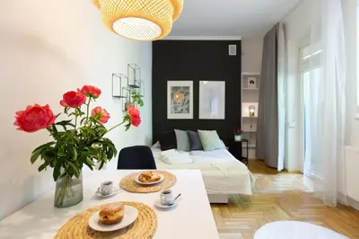 a living room with a table and a couch at May C studio w/balcony in Kraków