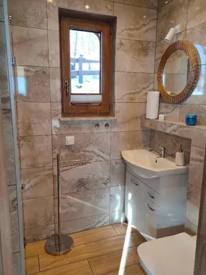 a bathroom with a shower and a sink at Pieśń Poranka Domek in Łysina