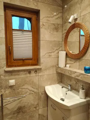 a bathroom with a sink and a mirror at Pieśń Poranka Domek in Łysina