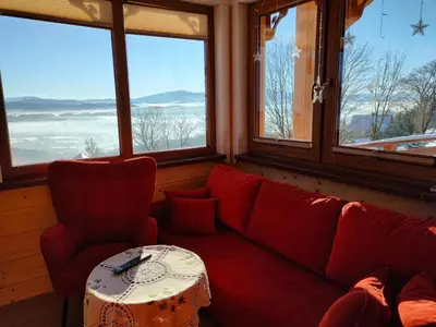 a living room with a red couch and a table at Pieśń Poranka Domek in Łysina