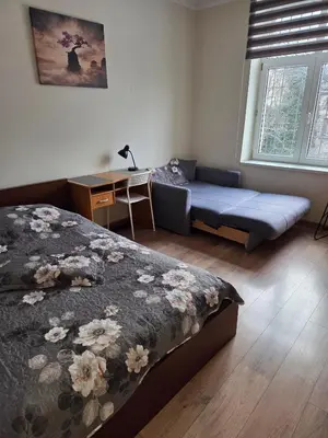 a bedroom with a bed and a couch and a desk at Apartamenty Marco 3-Bis- Przy Dworcu-Stare Miasto-Super Wi Fi in Kraków