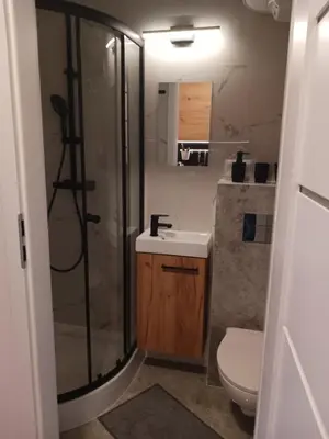 a bathroom with a shower and a sink and a toilet at Apartamenty Marco 3-Bis- Przy Dworcu-Stare Miasto-Super Wi Fi in Kraków