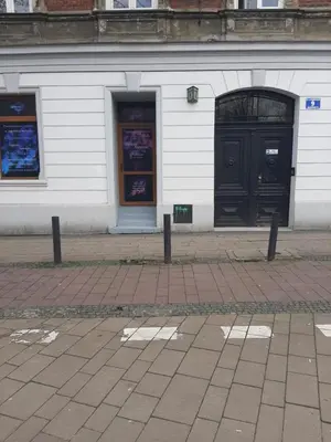 a building with two black doors on a street at Apartamenty Marco 3-Bis- Przy Dworcu-Stare Miasto-Super Wi Fi in Kraków
