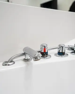 a close up of a bathroom counter with three faucets at Apartament z Jacuzzi Kraków SHADOW Zamoyskiego in Kraków
