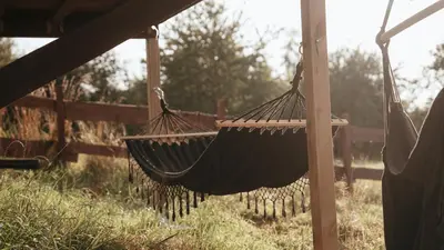 a hammock hanging from a fence in a yard at Dream Catcher House - dom do wynajęcia w górach in Limanowa