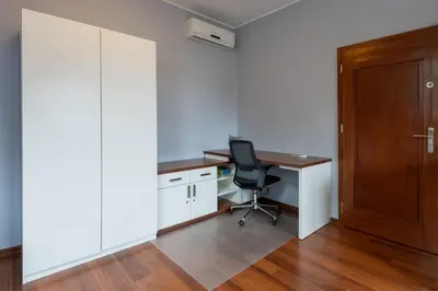 an office with a desk and a chair and a door at A comfortable apartment midway Kraków-Oświęcim in Chrzanów
