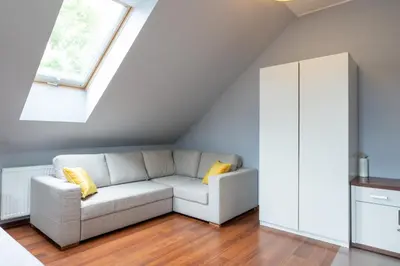 a living room with a couch and a window at A comfortable apartment midway Kraków-Oświęcim in Chrzanów