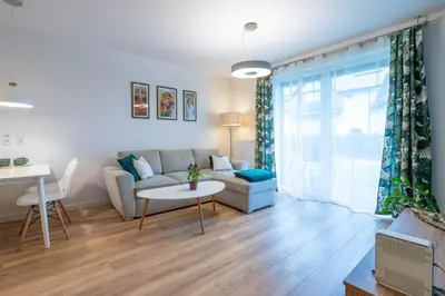 a living room with a couch and a table at Green Apartment Chrzanów in Chrzanów