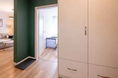 a room with a large white cabinet with a mirror at Green Apartment Chrzanów in Chrzanów