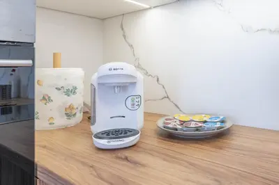 a food processor sitting on a counter next to a plate of food at Green Apartment Chrzanów in Chrzanów