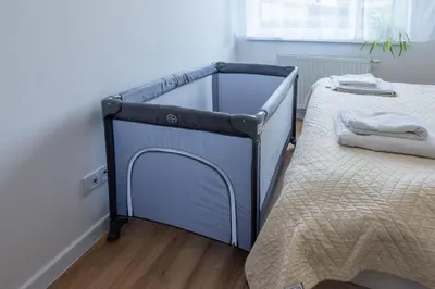 a bed with a blue frame in a bedroom at Green Apartment Chrzanów in Chrzanów