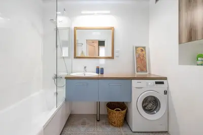 a bathroom with a sink and a washing machine at Green Apartment Chrzanów in Chrzanów