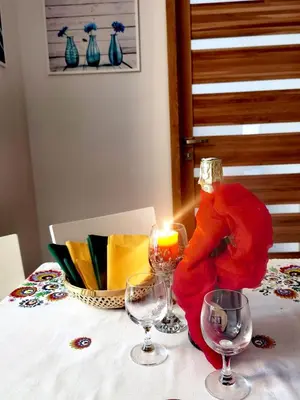 a table with a candle and wine glasses on it at apart Wilga in Kraków