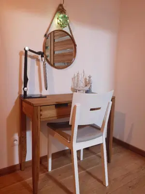 a desk with a mirror and a white chair at apart Wilga in Kraków