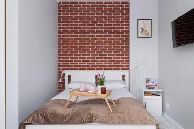 a bedroom with a bed with a table on it at Dąbska Studio with Terrace & Parking by Noclegi Renters in Kraków