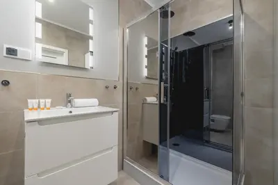 a bathroom with a shower and a sink and a toilet at Dąbska Studio with Terrace & Parking by Noclegi Renters in Kraków