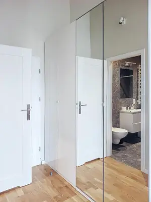 a bathroom with glass doors and a toilet and a sink at Estery Studio Heart of Kazimierz in Kraków