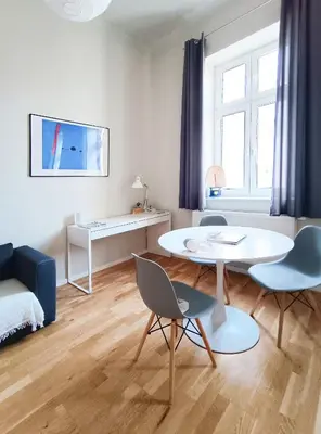 a living room with a white table and chairs at Estery Studio Heart of Kazimierz in Kraków