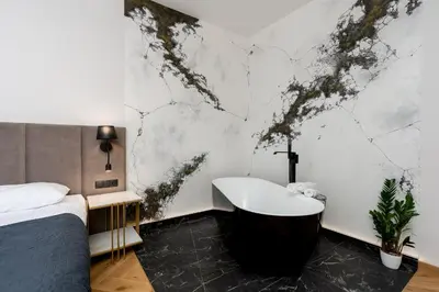 a bedroom with a bed and a bath tub at SPA bedrooms with Sauna&Bath and Free Parking in Kraków