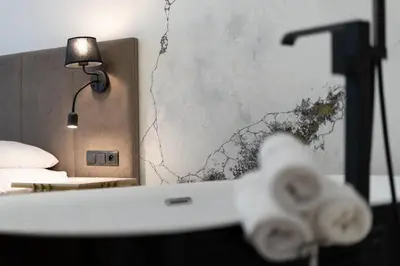 a room with a bed and a table with towels at SPA bedrooms with Sauna&Bath and Free Parking in Kraków