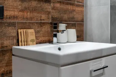 a bathroom sink with two rolls of toilet paper on it at SPA bedrooms with Sauna&Bath and Free Parking in Kraków