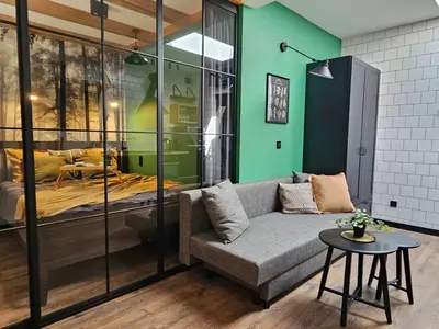 a living room with a couch and a bedroom at Cracovia Luxury Bright Apartment Great Location Sauna in Kraków
