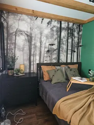 a bedroom with a bed with a forest mural at Cracovia Luxury Bright Apartment Great Location Sauna in Kraków