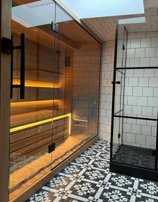 an empty shower stall with a glass door at Cracovia Luxury Bright Apartment Great Location Sauna in Kraków
