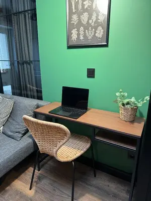 a desk with a laptop on top of a couch at Cracovia Luxury Bright Apartment Great Location Sauna in Kraków