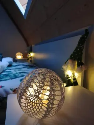 a room with a ball on a table next to a bed at Zaciszny Zakątek Zawoja in Zawoja