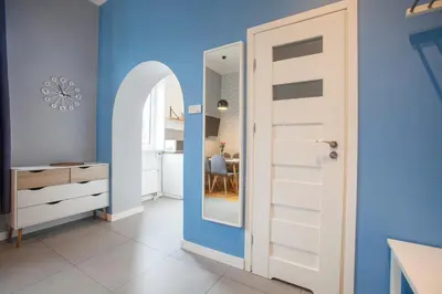 a room with a blue wall and a door at Smart Old Town Apartment in Kraków