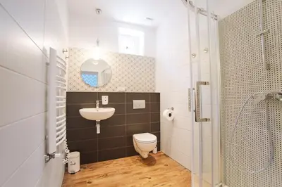 a bathroom with a sink and a toilet and a shower at Smart Old Town Apartment in Kraków
