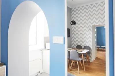 a kitchen and dining room with a table and chairs at Smart Old Town Apartment in Kraków