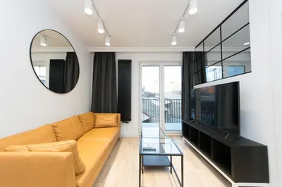 a living room with a couch and a mirror at Ghetto Heroes Square Lwowska 10 A/C p4you pl in Kraków