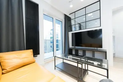 a living room with a tv and a couch at Ghetto Heroes Square Lwowska 10 A/C p4you pl in Kraków