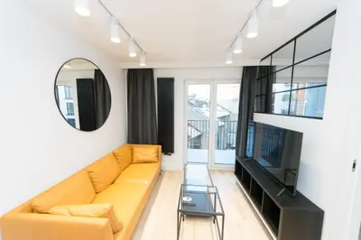 a living room with a couch and a flat screen tv at Ghetto Heroes Square Lwowska 10 A/C p4you pl in Kraków