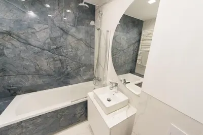 a bathroom with a sink and a bath tub at Ghetto Heroes Square Lwowska 10 A/C p4you pl in Kraków