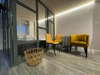 a dining room with yellow chairs and a table at Balcony Bliss Main Square Loft in Kraków