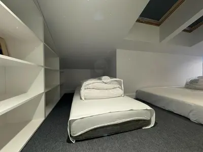a white room with a bed and shelves at Balcony Bliss Main Square Loft in Kraków