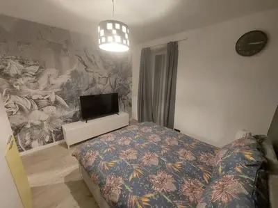 a bedroom with a bed and a tv on a wall at Apartament nad Wisłą, bezpłatny parking, AWG APARTMENTS in Kraków