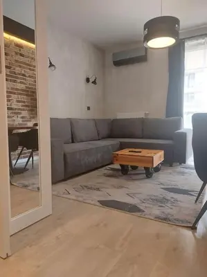 a living room with a couch and a coffee table at Apartament nad Wisłą, bezpłatny parking, AWG APARTMENTS in Kraków