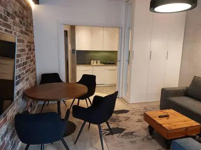 a living room with a table and chairs and a couch at Apartament nad Wisłą, bezpłatny parking, AWG APARTMENTS in Kraków