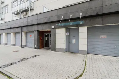 a building with four garage doors on the side of it at Deluxe Loft Apartment Lubelska with Mezzanine by Noclegi Renters in Kraków