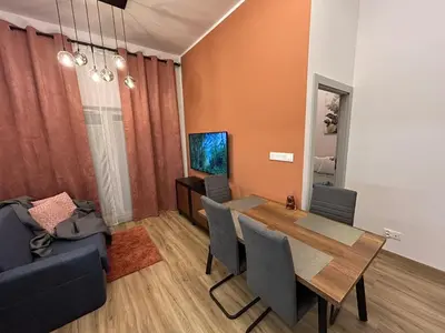 a dining room with a table and a couch at New comfortable apartment with patio on Klimeckiego street in Kraków