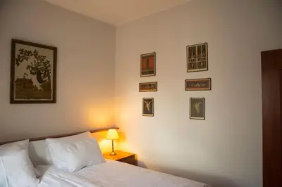 a bedroom with a bed and pictures on the wall at Kompleksowo wyposażony apartament w centrum in Kraków